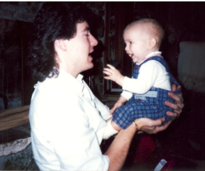 Mike holding and laughing with a baby
