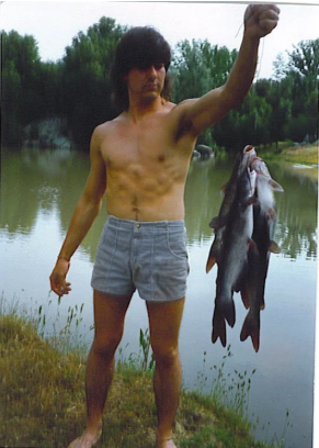 Mike with his fishing catch by the river