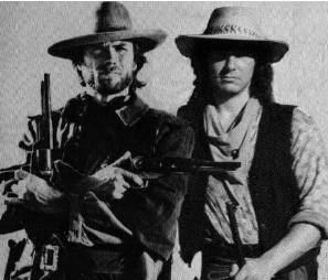 Mike in a black and white western photo with a fellow performer